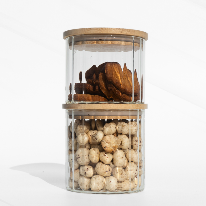 A fluted high borosilicate glass storage jar with a wooden lid, featuring a modern textured design and airtight sealing for stylish kitchen organization.