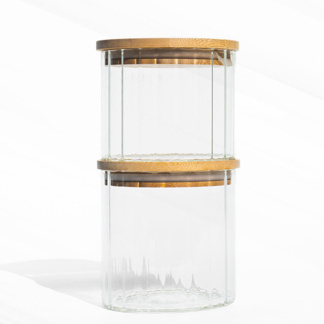 A fluted high borosilicate glass storage jar with a wooden lid, featuring a modern textured design and airtight sealing for stylish kitchen organization.