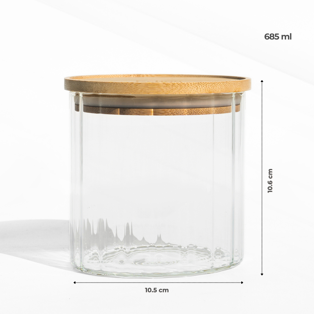 A fluted high borosilicate glass storage jar with a wooden lid, featuring a modern textured design and airtight sealing for stylish kitchen organization.