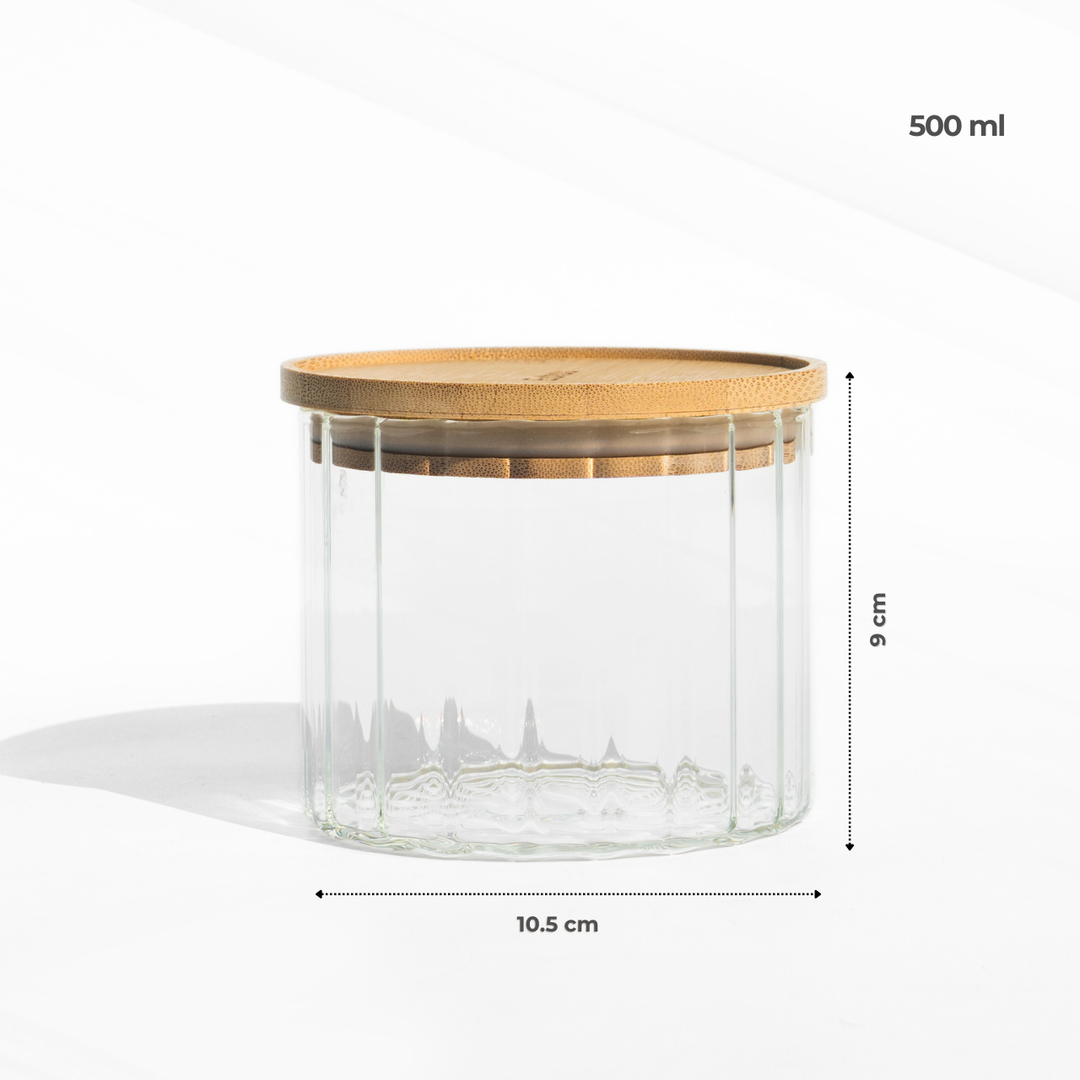 A fluted high borosilicate glass storage jar with a wooden lid, featuring a modern textured design and airtight sealing for stylish kitchen organization.